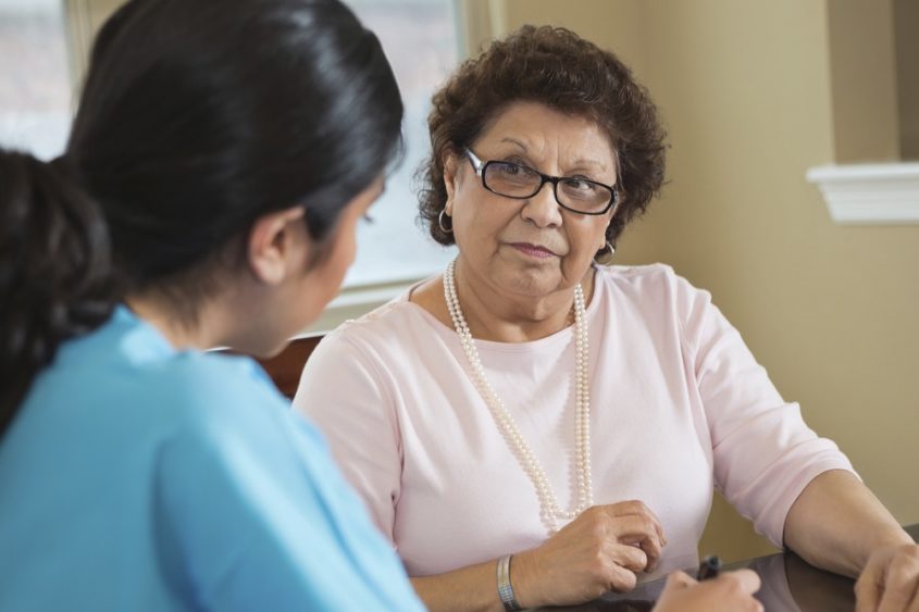 older woman talking with a healthcare professional