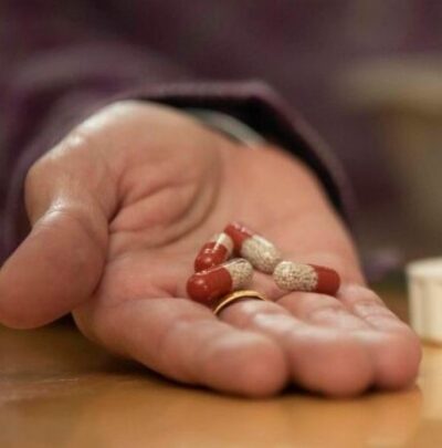 PERT capsules held in someone's hand