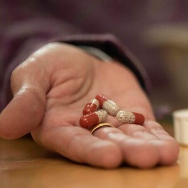 PERT capsules held in someone's hand