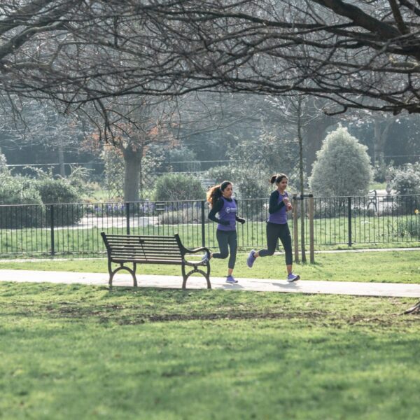Two females running through a park