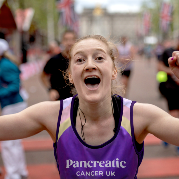 Runner celebrating crossing the London Marathon finish line