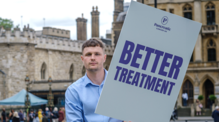 PCUK campaigner in Westminster holding a placard saying Better Treatment