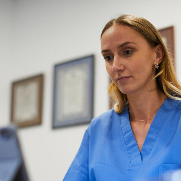 Health professional watching a webinar on a computer