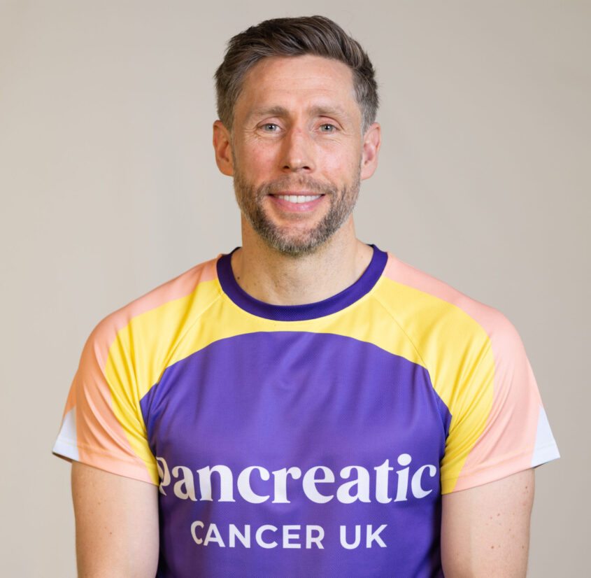 phil the coach of london marathon for pcuk in a pancreatic cancer uk top staring at the camera