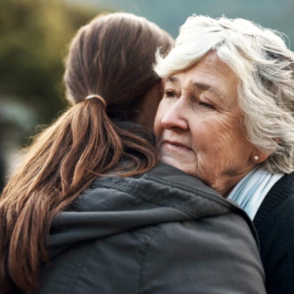 An older woman hugging a younger woman