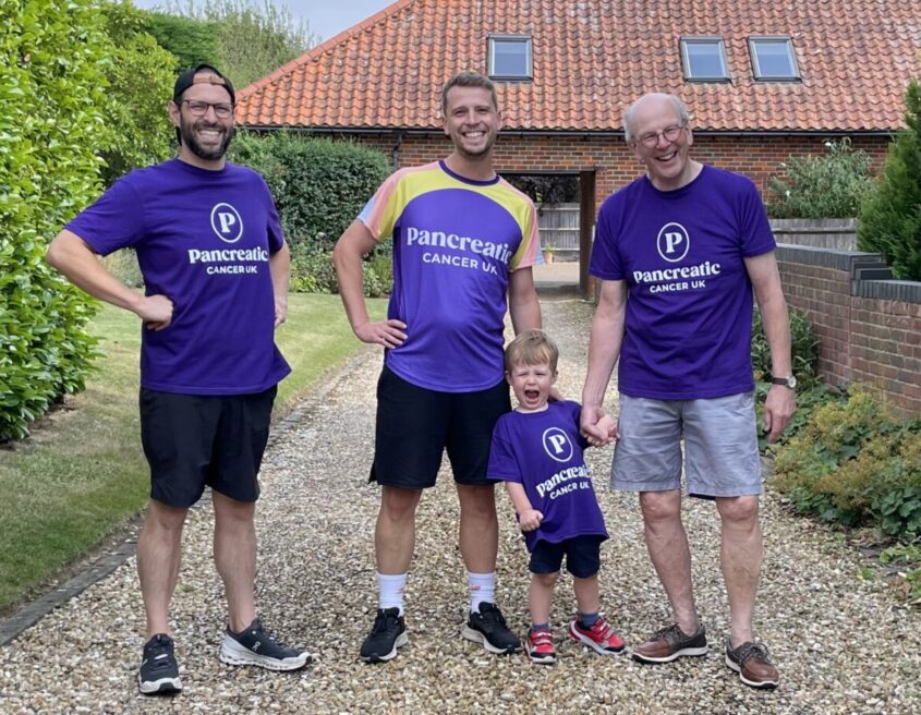 Three men and a little boy standing in a driveway wearing pancreatic cancer uk tops