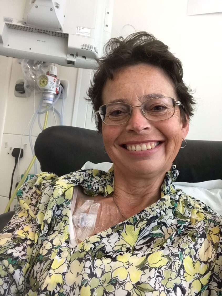 woman in clinic or hospital setting smiling at camera