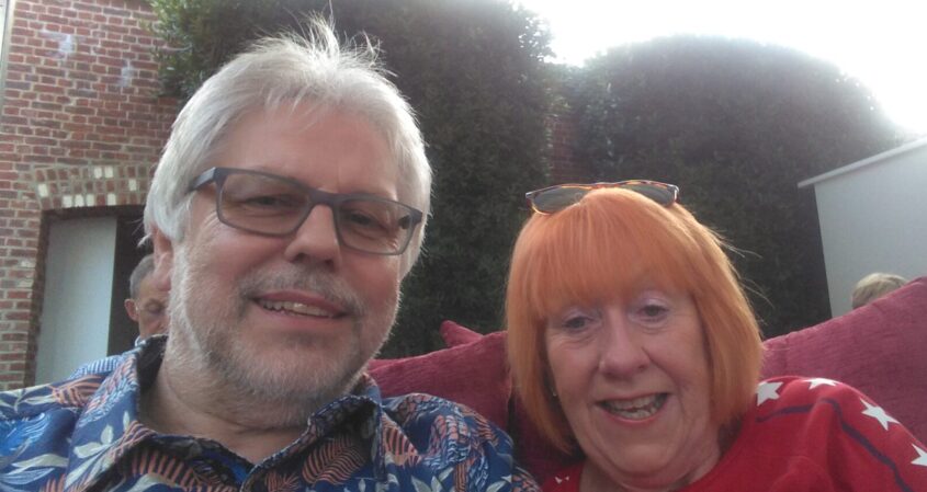 Man and woman sitting together smiling towards camera