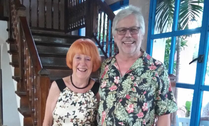 Man and woman standing together and smiling at the camera