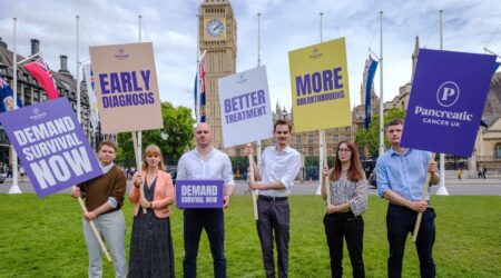 group of people at parliament holding signs