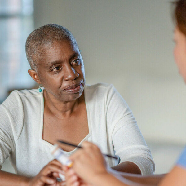 a person sitting and listening to someone talk