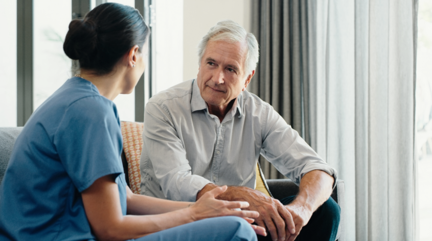 Older man talking with healthcare professional