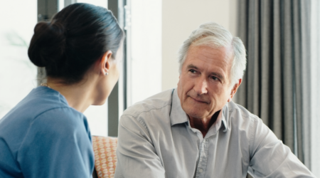 Older man talking with healthcare professional