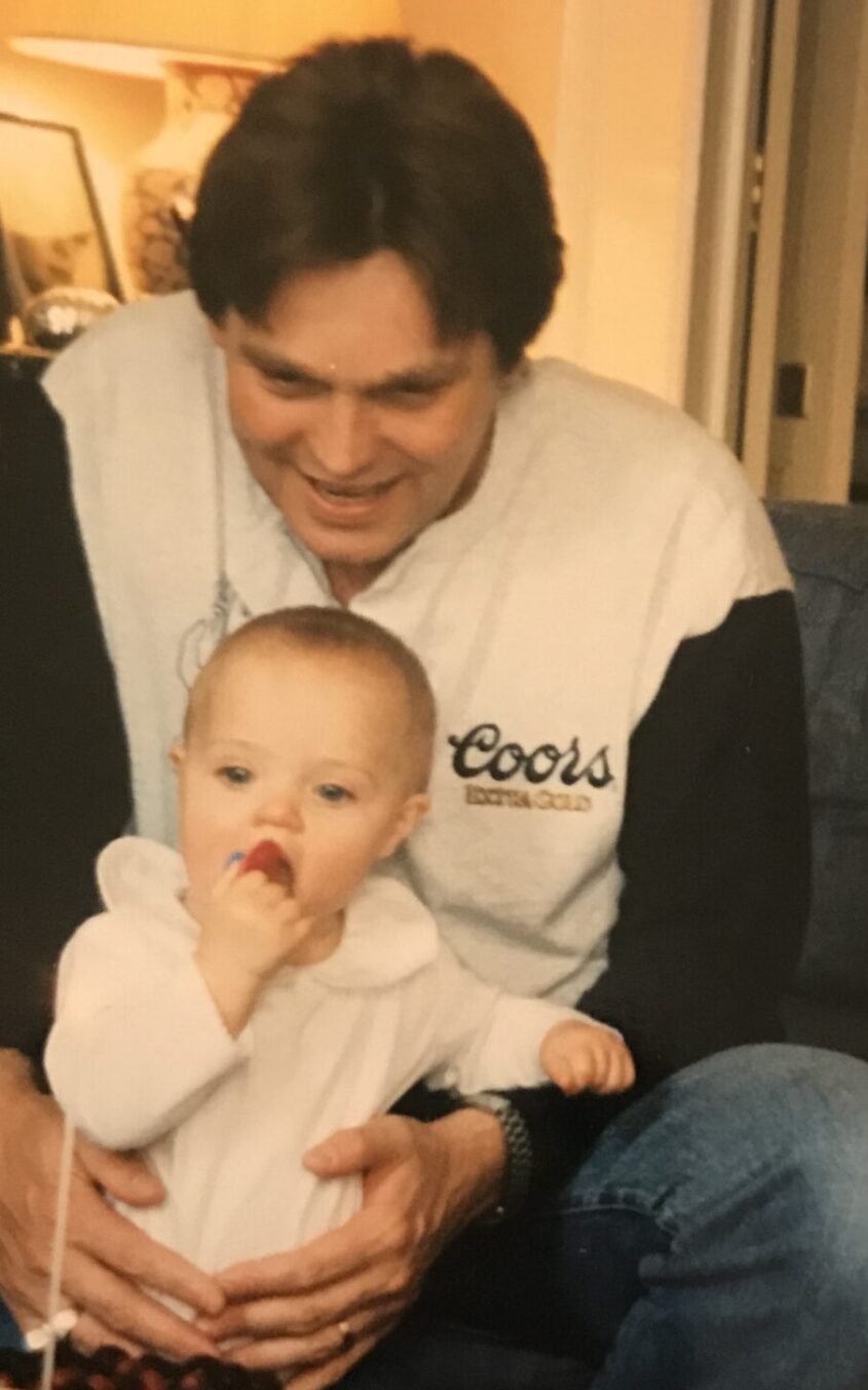 Man holding baby, sitting in front of table